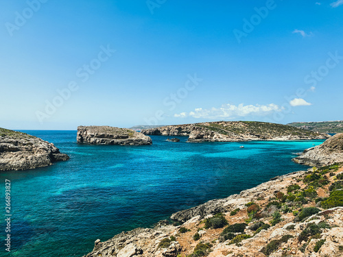 Islands with clear turquoise water in Mediterranean sea. Nature summer seascape in Malta. Travel and tourism in summer time concept. Malta  Comino Island