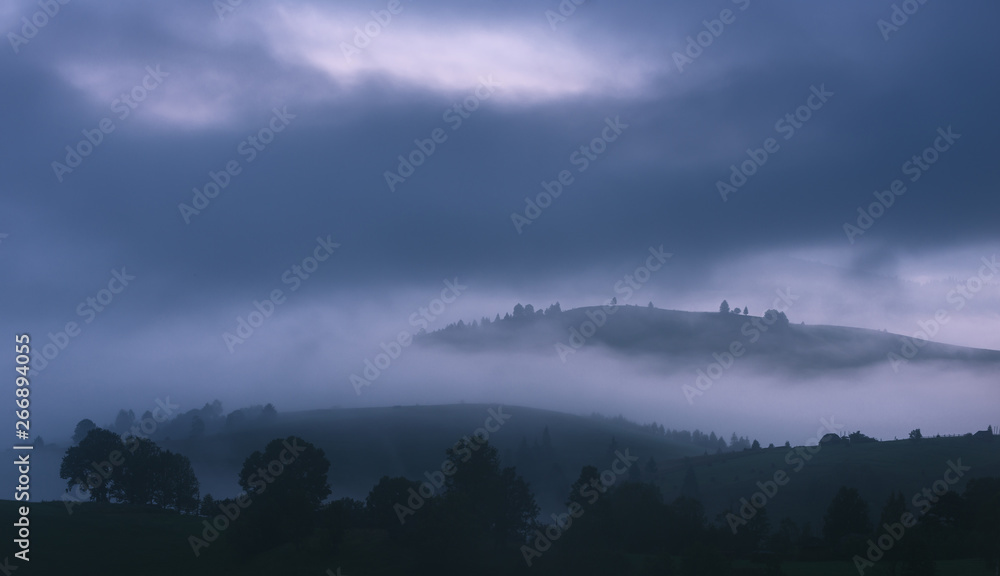 Misty hills at gloomy morning