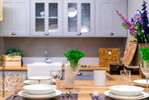 kitchen interior with gray facade. serving the kitchen table. flowers in the kitchen;