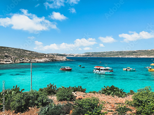 Blue lagoon Comino Island. Turquoise blue water, boats. Travel and tourism in Comino Isalnd, Malta concept