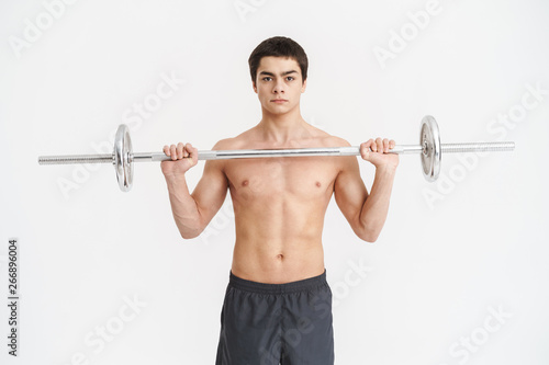 Confident fit young shirtless sportsman doing exercises