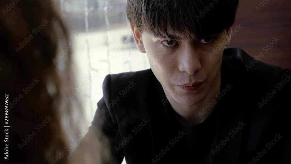 Cute young man talking with a woman on a date, interesting conversation. Cute young man talking with a woman on a date, interesting conversation.