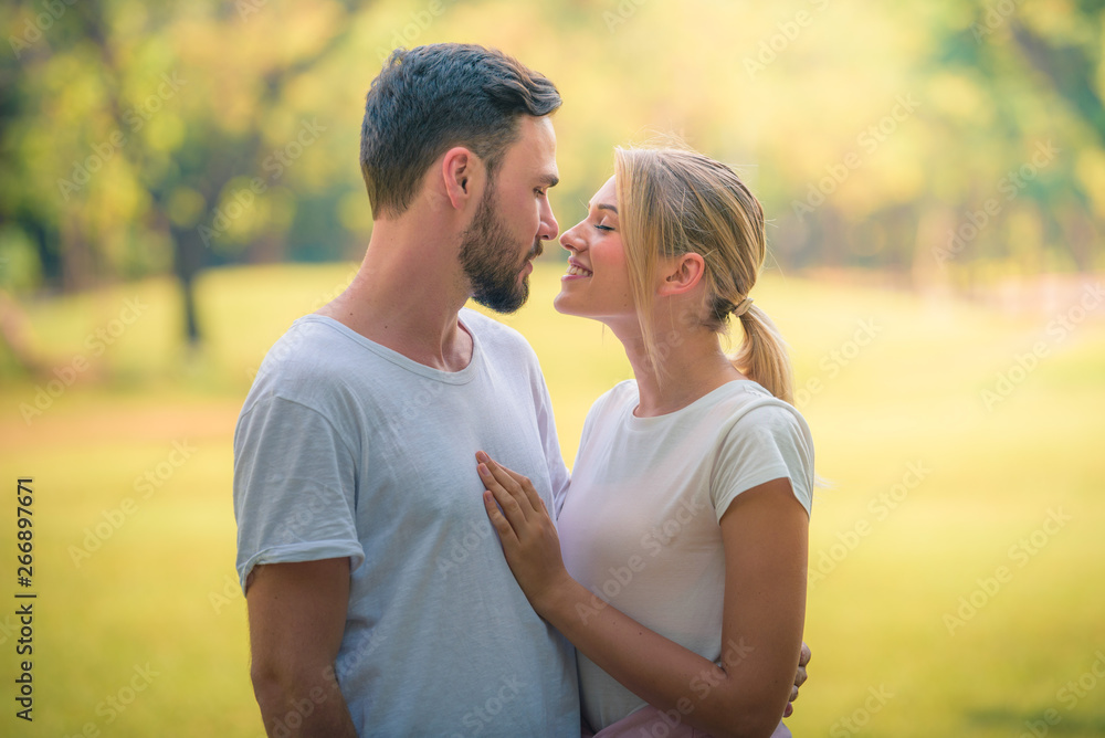 Portrait image of Young couple enjoying in the park at sunset. Concept romantic and love. Warm tone. Portrait image of Young couple enjoying in the park at sunset. Concept romantic and love. Warm tone.