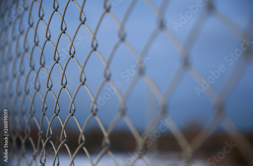 Detail of a fence with abstract background.
