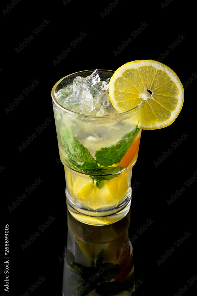 Alcoholic or non-alcoholic cocktail with lemon, lime and cucumber with the addition of liquor, vodka, champagne or martini. Cool drink isolated on black background. Cocktail card for a bar Alcoholic or non-alcoholic cocktail with lemon, lime and cucumber with the addition of liquor, vodka, champagne or martini. Cool drink isolated on black background. Cocktail card for a bar