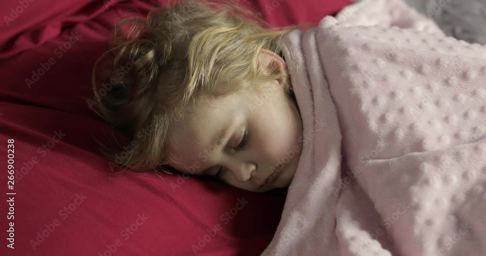 Cute baby sleeping on the bed at home. Little girl sleeping in morning light Cute baby sleeping on the bed at home. Little girl sleeping in morning light