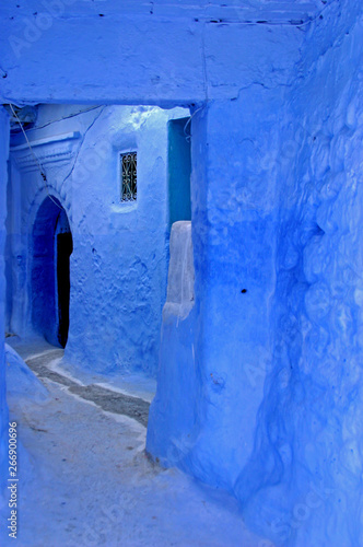 Old wall and door in the moroccan blue city Chefchaouen © ISsam