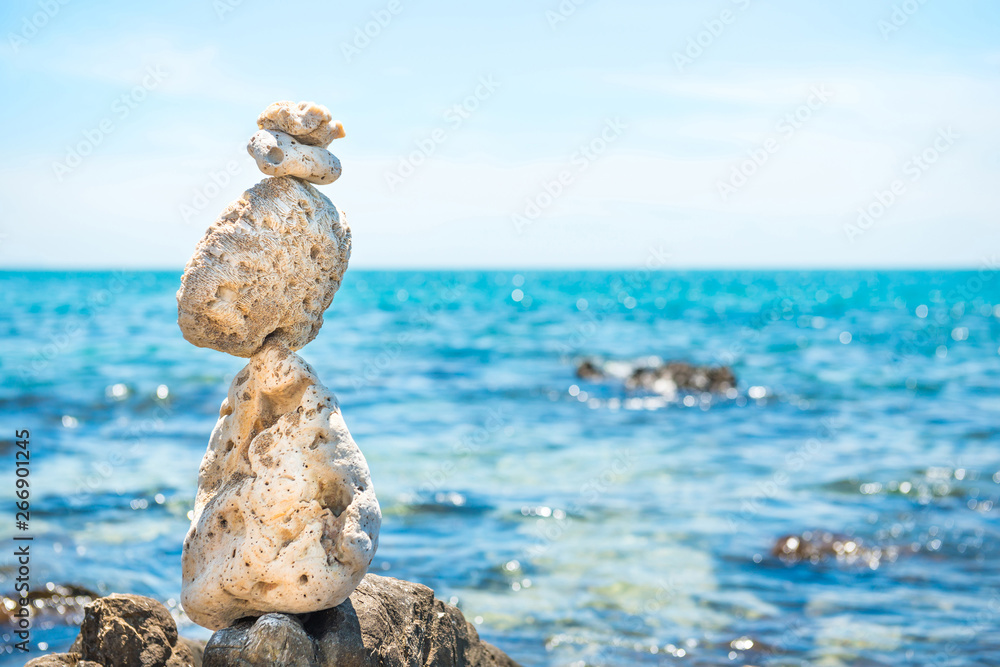 Zen stones balance at stony beach and sea background Zen stones balance at stony beach and sea background