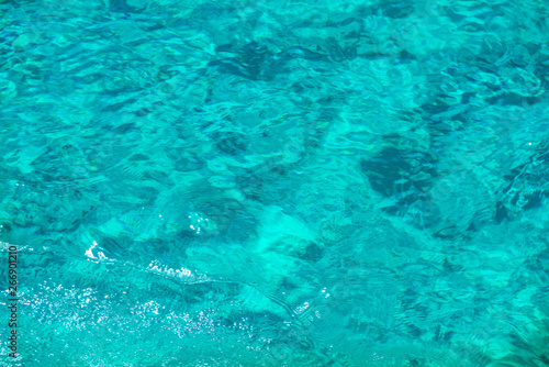 Texture of clear turquoise sea water surface. Can be used as summer background © Pavlo Vakhrushev