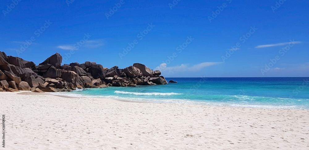 Naklejka premium Seychelles with white sand, azure ocean and blue sky. Open place.