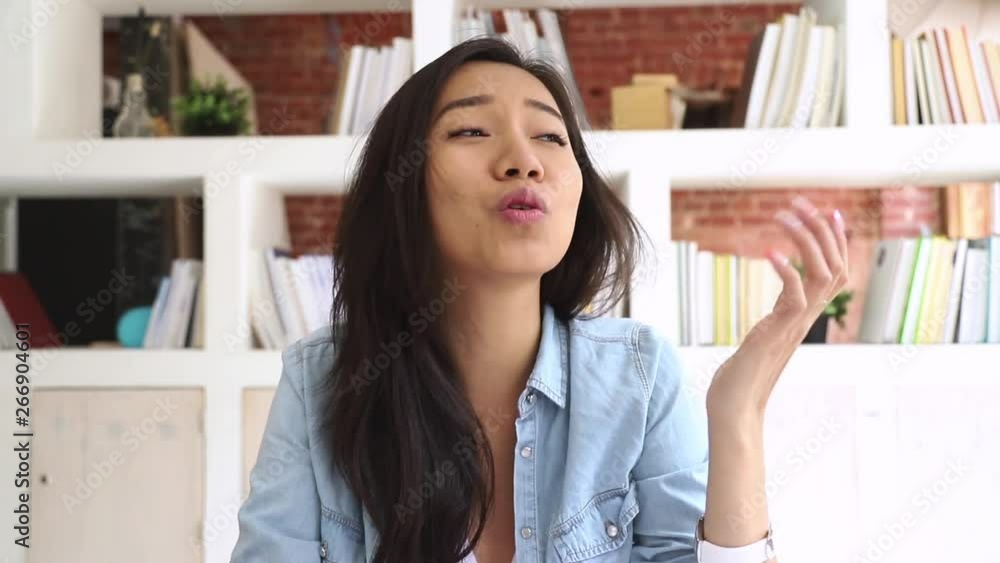 Happy asian girl student looking at camera making video call