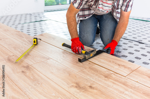 Wallpaper Mural Handyman installing new laminated wooden floor Torontodigital.ca