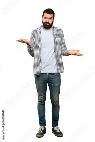 Handsome man with beard unhappy for not understand something over isolated white background