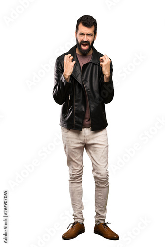 Handsome man with beard frustrated by a bad situation over isolated white background