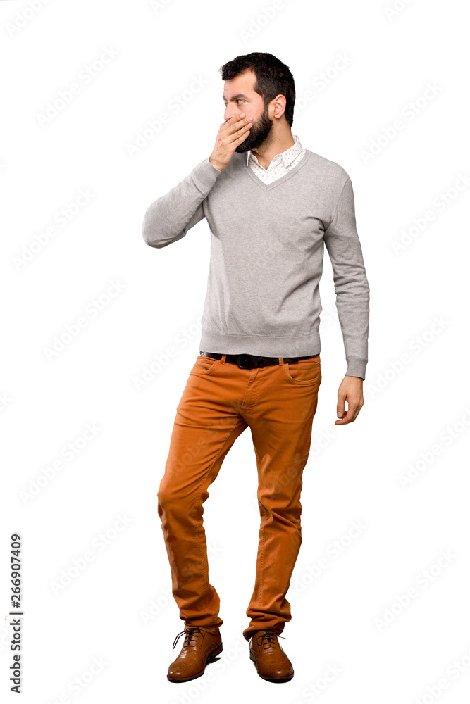 Handsome man covering mouth with hands over isolated white background Handsome man covering mouth with hands over isolated white background