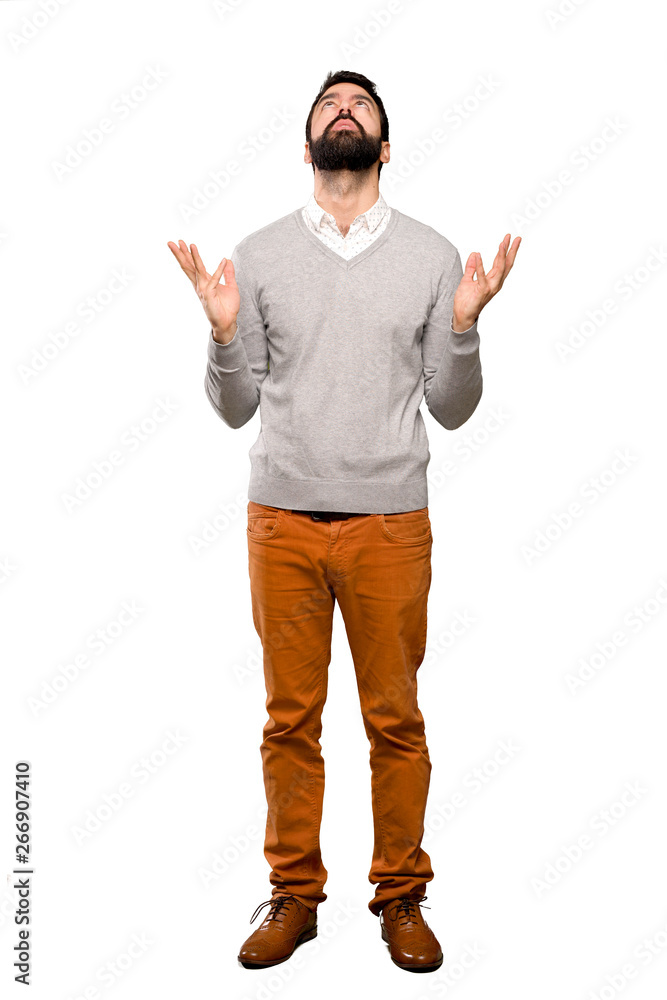 Handsome man frustrated by a bad situation over isolated white background Handsome man frustrated by a bad situation over isolated white background