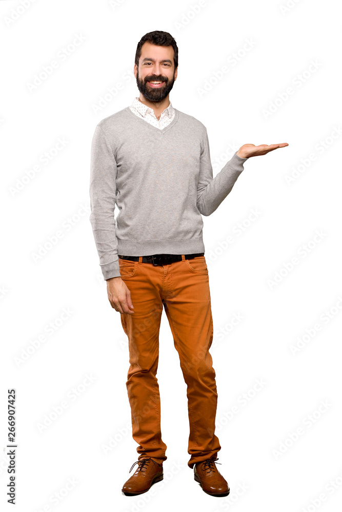 Handsome man holding copyspace imaginary on the palm to insert an ad over isolated white background Handsome man holding copyspace imaginary on the palm to insert an ad over isolated white background