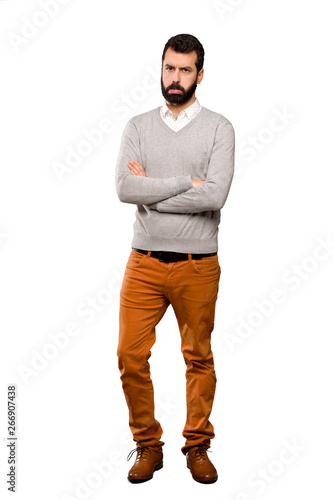 Handsome man with sad and depressed expression over isolated white background