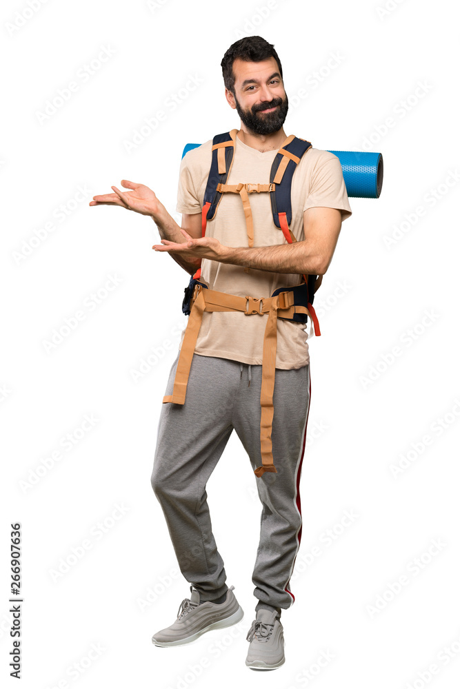 Hiker man extending hands to the side for inviting to come over isolated white background Hiker man extending hands to the side for inviting to come over isolated white background