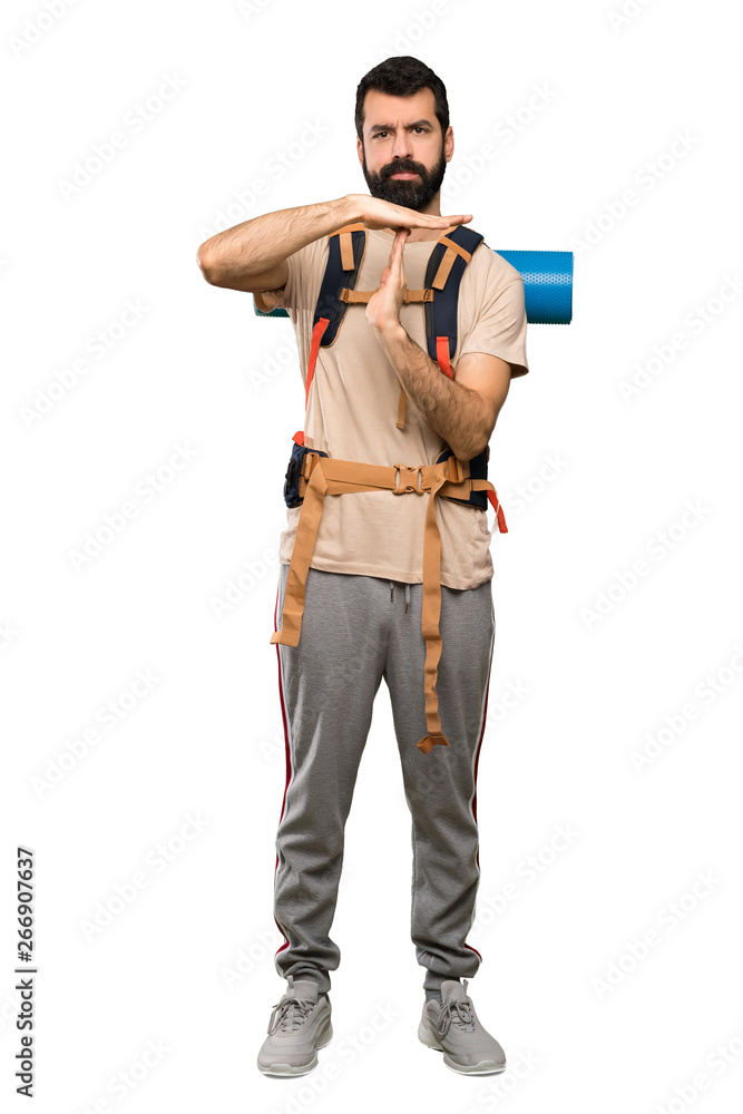 Hiker man making time out gesture over isolated white background Hiker man making time out gesture over isolated white background