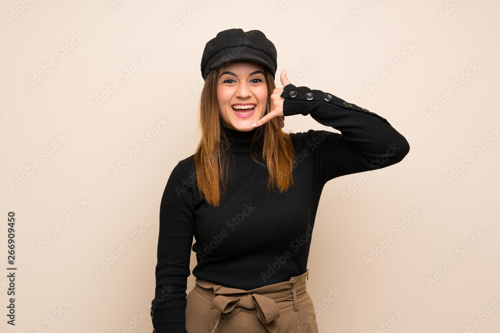Fashion woman with hat making phone gesture. Call me back sign Fashion woman with hat making phone gesture. Call me back sign