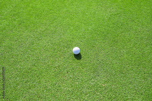 Golf Course with Golf Ball on putting green. Golf is a sport to play on the turf.