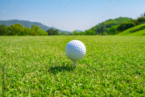 Golf Course with Golf Ball on tee. Golf course with a rich green turf beautiful scenery.