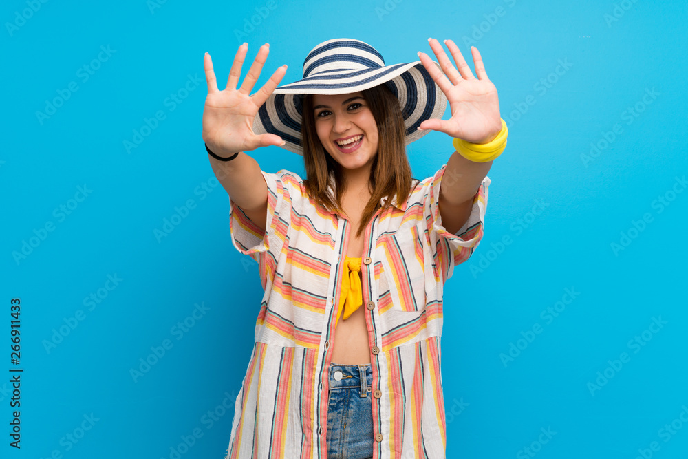 Young woman in bikini in summer holidays counting ten with fingers Young woman in bikini in summer holidays counting ten with fingers