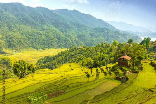 Beautiful green valley and single rock house on a hill. photo