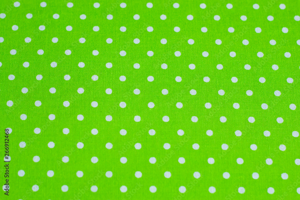green polka dot fabrics as a sewing background