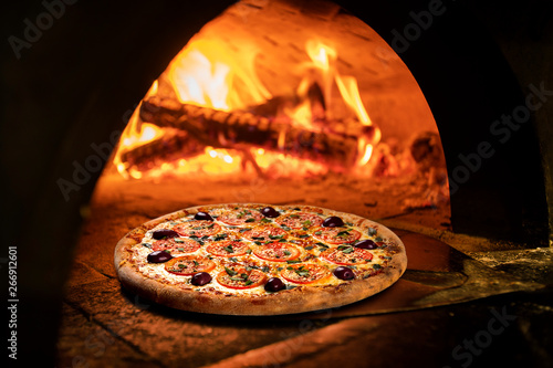 Image of a brick pizza oven with fire photo