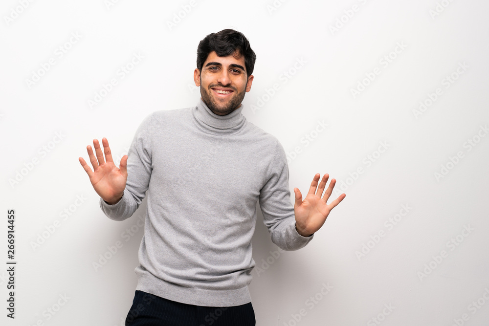 Young man over isolated white wall smiling Young man over isolated white wall smiling