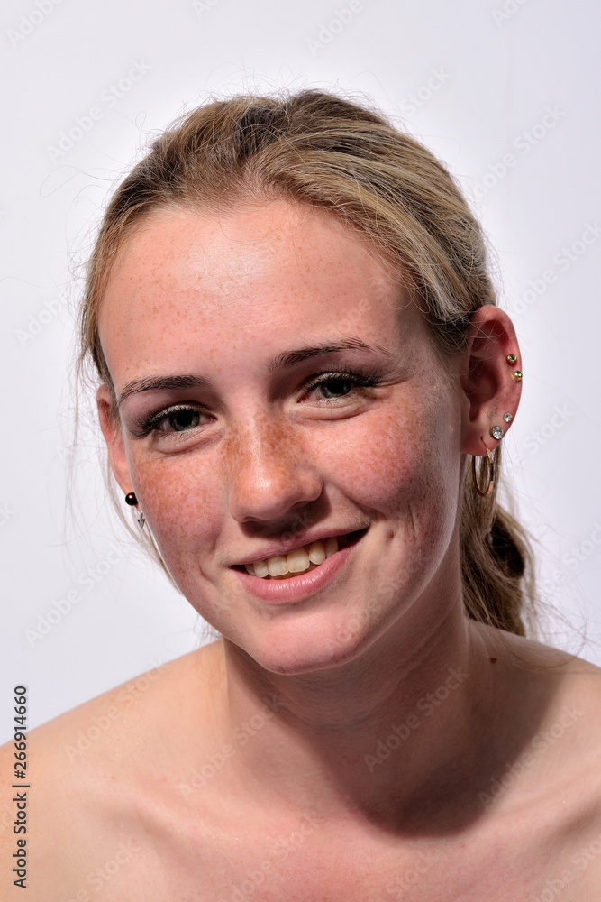 portrait of a young beautiful girl with blue eyes and freckles on a white background portrait of a young beautiful girl with blue eyes and freckles on a white background