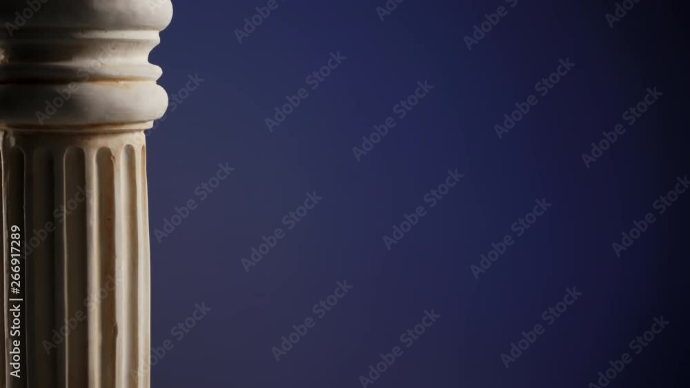 Single ancient greek column rotating slowly on color background, copy space text area Single ancient greek column rotating slowly on color background, copy space text area