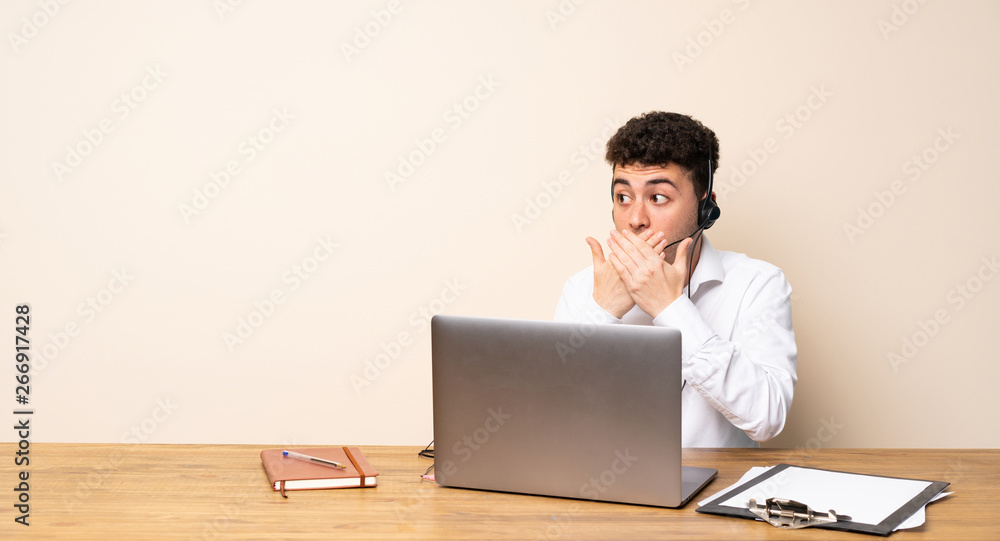 Telemarketer man covering mouth and looking to the side Telemarketer man covering mouth and looking to the side
