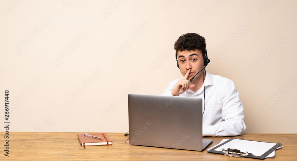 Telemarketer man showing a sign of silence gesture putting finger in mouth Telemarketer man showing a sign of silence gesture putting finger in mouth