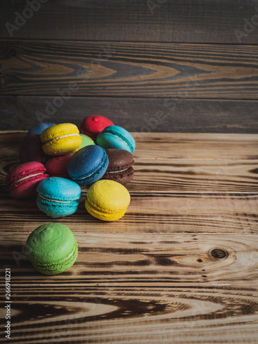 multicolored macaroon on a dark wooden table