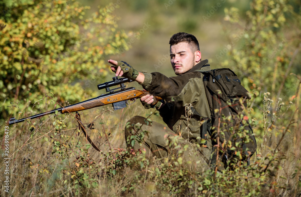 Hunter hold rifle. Hunting permit. Bearded serious hunter spend leisure hunting. Hunting equipment for professionals. Hunting is brutal masculine hobby. Man wear camouflage clothes nature background Hunter hold rifle. Hunting permit. Bearded serious hunter spend leisure hunting. Hunting equipment for professionals. Hunting is brutal masculine hobby. Man wear camouflage clothes nature background