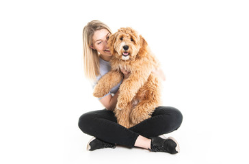 woman with his Golden Labradoodle dog isolated on white background