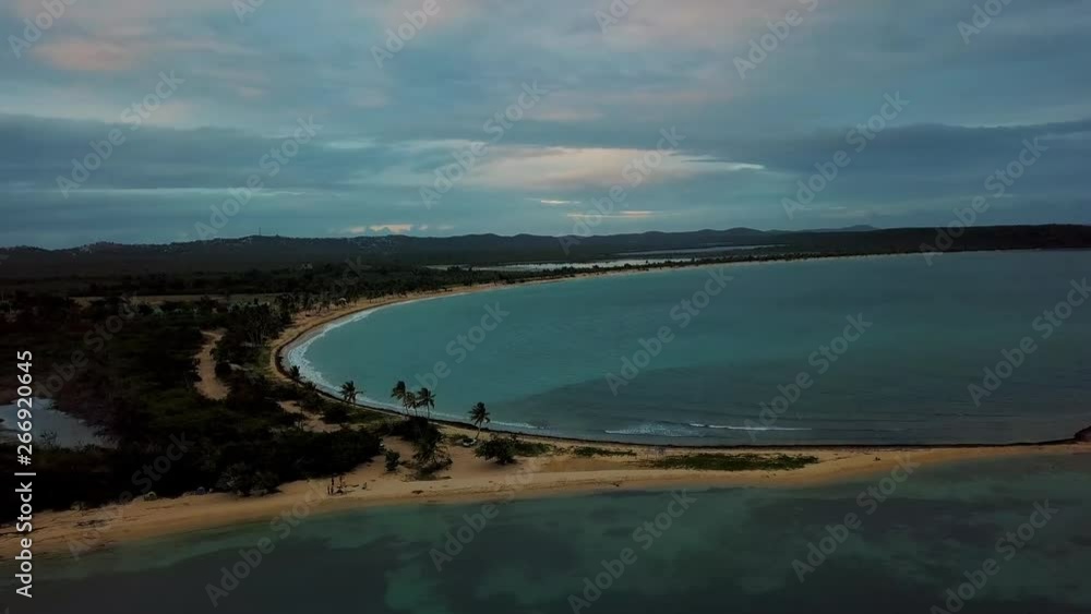 View of the bay of the small town of Esmeralda located in Vieques Puerto Rico during sunset and dusk with beautiful vivid colors among boats, islands, and coast. View of the bay of the small town of Esmeralda located in Vieques Puerto Rico during sunset and dusk with beautiful vivid colors among boats, islands, and coast.