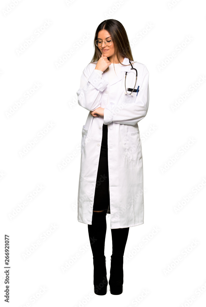 Full body of Young doctor woman looking down with the hand on the chin Full body of Young doctor woman looking down with the hand on the chin
