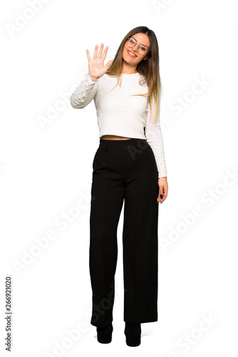 Full body of Pretty woman with glasses counting five with fingers