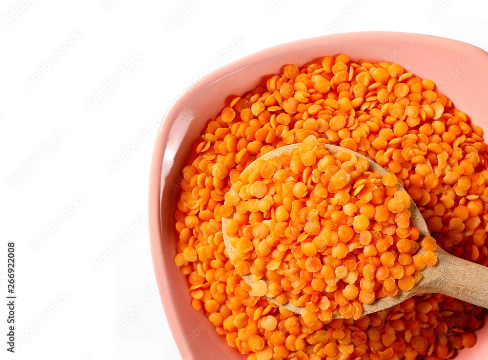 Red lentils with bowl and wooden spoon isolated on white, top view Red lentils with bowl and wooden spoon isolated on white, top view