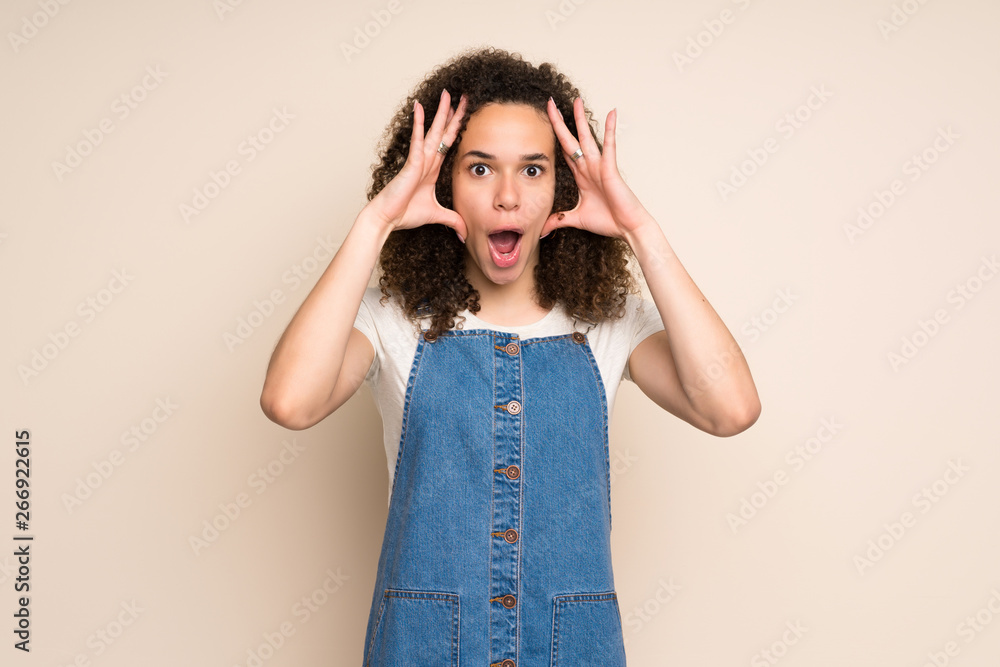 Dominican woman with overalls with surprise expression Dominican woman with overalls with surprise expression