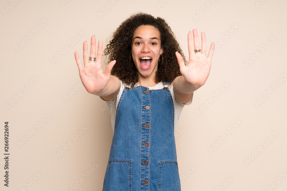 Dominican woman with overalls counting ten with fingers Dominican woman with overalls counting ten with fingers