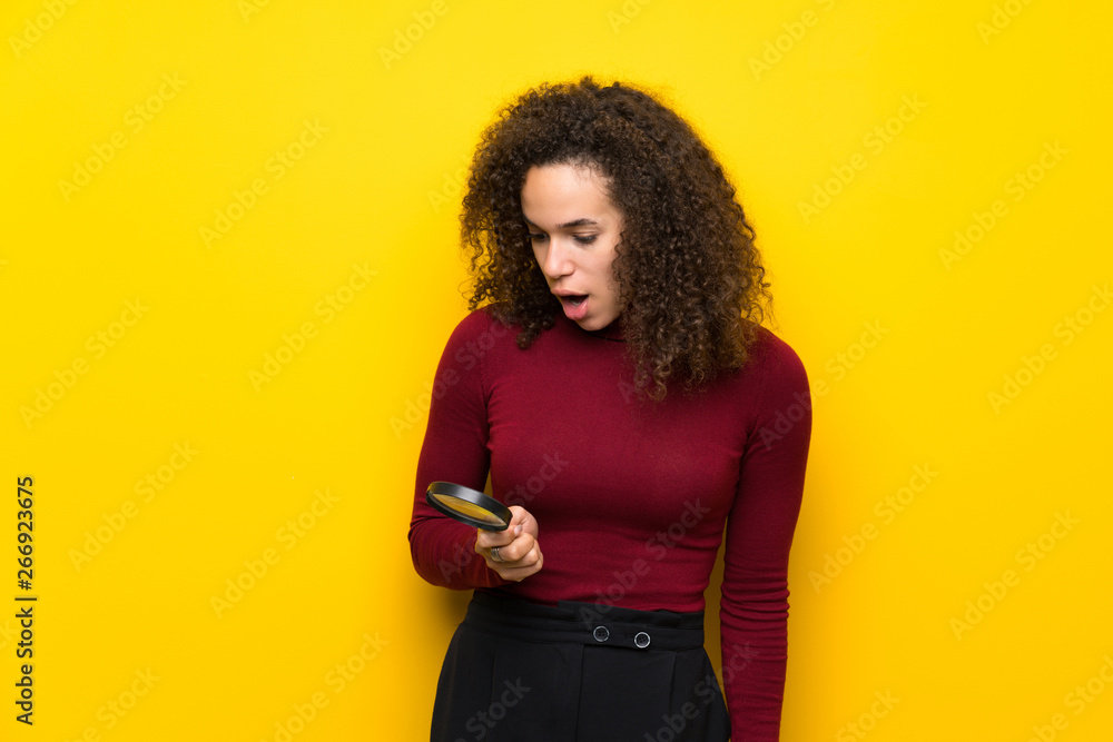 Dominican woman with turtleneck sweater holding a magnifying glass Dominican woman with turtleneck sweater holding a magnifying glass