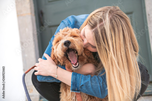 Labradoodle Dog and woman outside on balcony photo