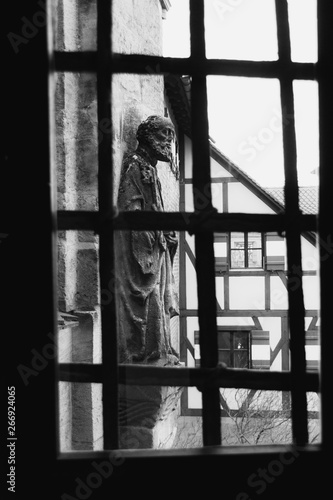 Statue through barred window in Nuremburg, Germany © David S. Murphy