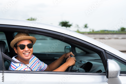 Young asian man driving car. Relaxing, Holiday, Activities, travel, Insurance agent concept. © Nopphon