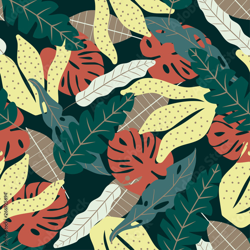 Seamless pattern with colorful tropical leaves on dark background. Vector design. Flat jungle print. Floral background.